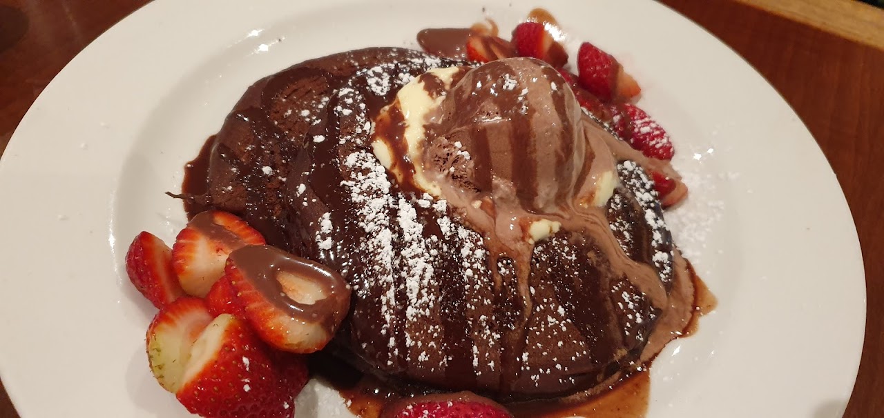 Chocolate pancakes with strawberries and ice cream at Pancakes On The Rocks