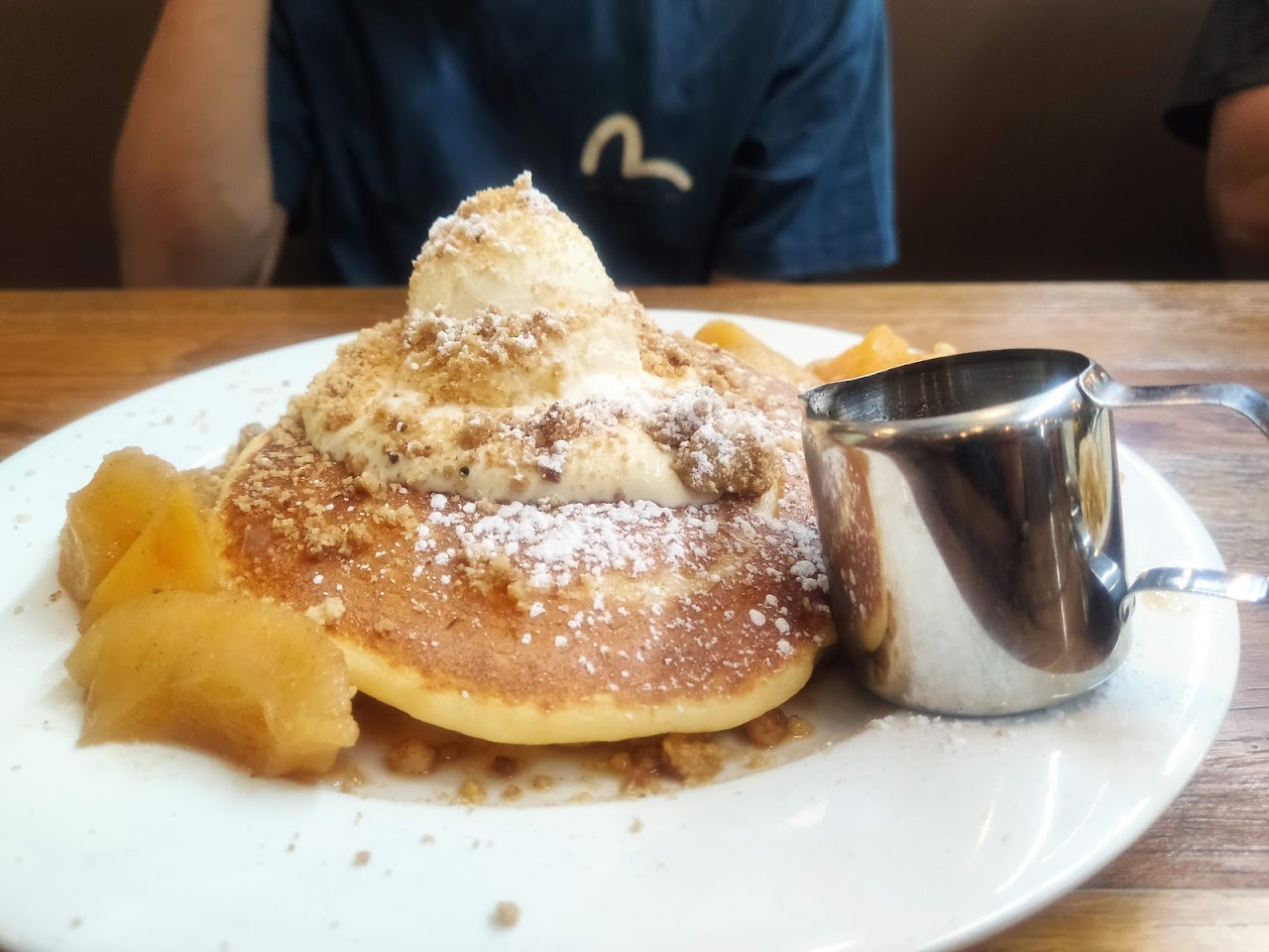 Apple crumble pancake with cream and syrup