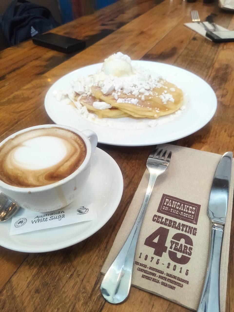 Coffee, pancake plate, and branded Pancakes On The Rocks napkin